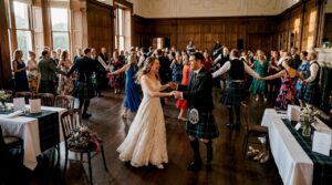 Bride and guests dancing Scottish ceilidh