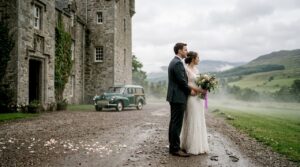 Couple outside Scottish castle at wedding