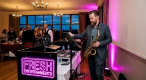 Saxophonist setting up with DJ at wedding