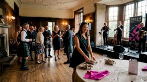 Guests gathering on dance floor at Scottish wedding