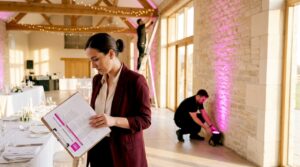 Wedding planner reviews lighting in event hall