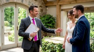 Event host guiding a Scottish wedding couple