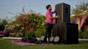 Technician adjusting PA speaker during event setup