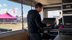 Sound engineer setting up outdoor event audio system